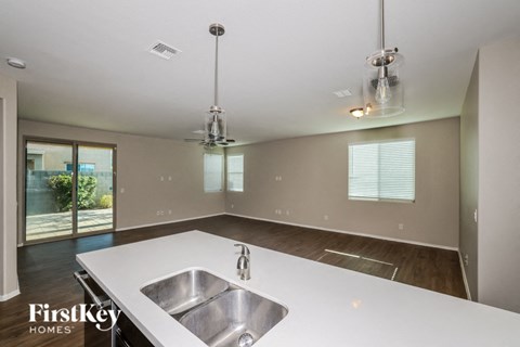 a kitchen with a stainless steel sink and a white counter