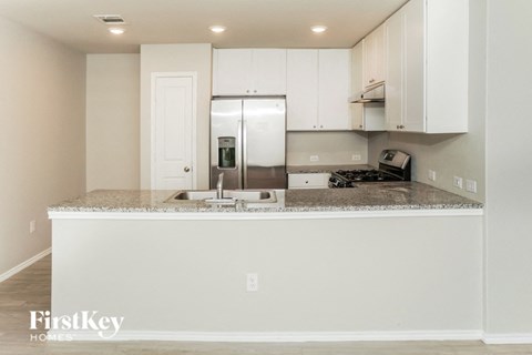 a kitchen with white cabinets and a counter top
