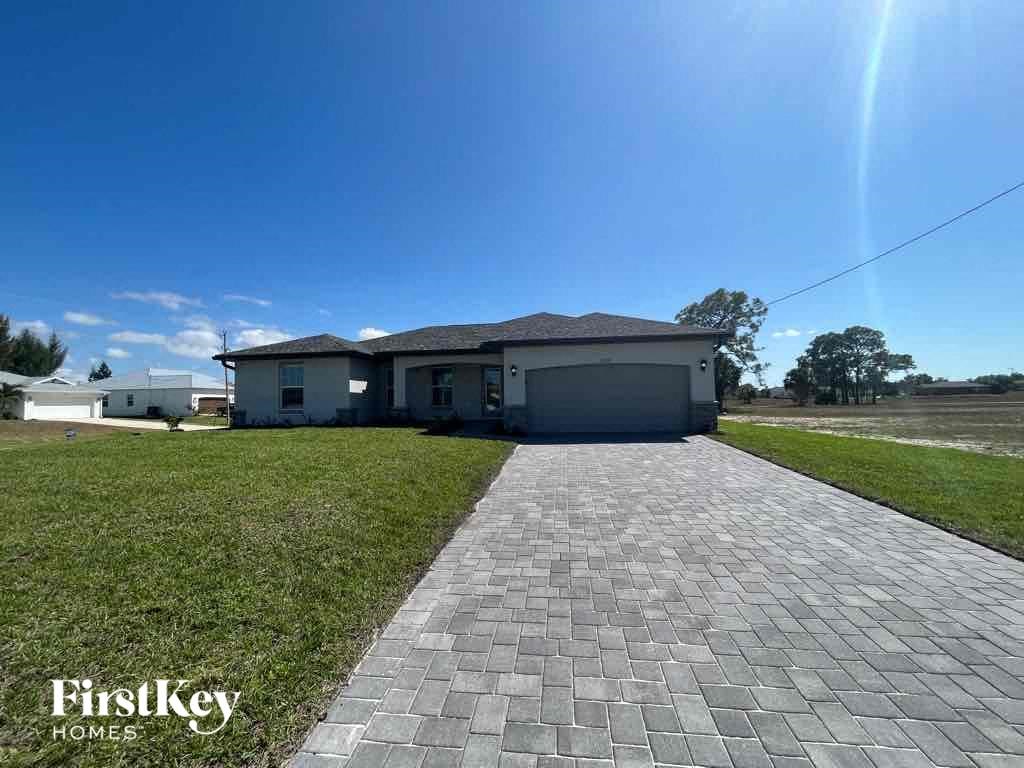 A house with a brick pathway leading to it and the words "FirstKey Homes" on the bottom left.