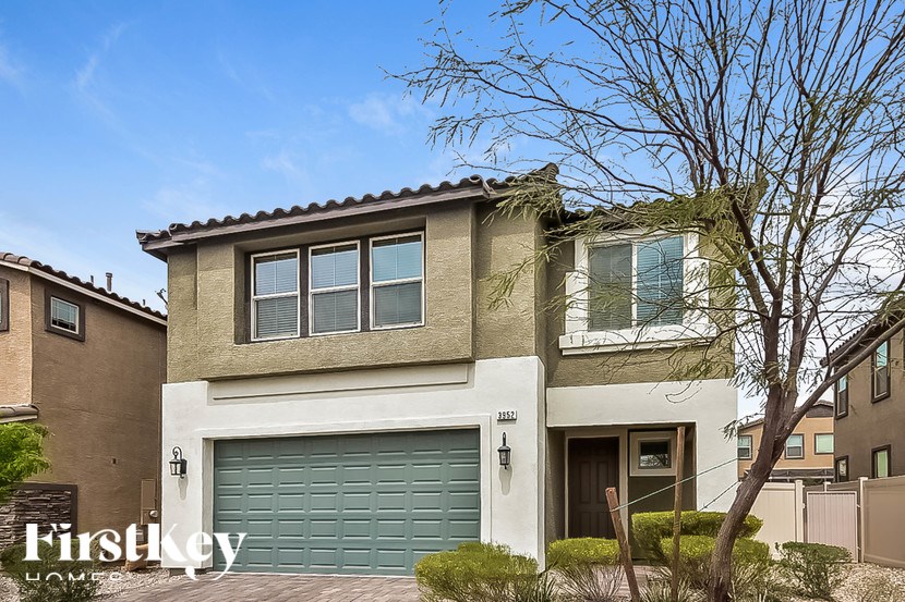 A house with a garage door is for sale.