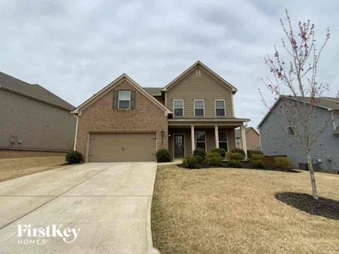 A house with a driveway in front of it.