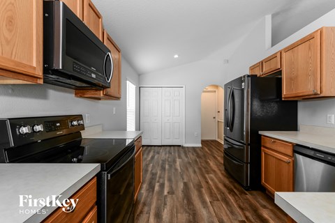 a kitchen with black appliances and wooden cabinets
