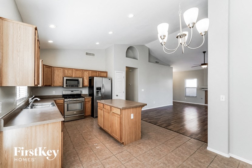 A kitchen with wooden cabinets and a countertop is shown.