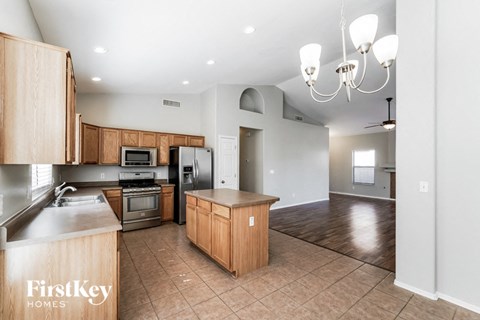 A kitchen with wooden cabinets and a countertop is shown.