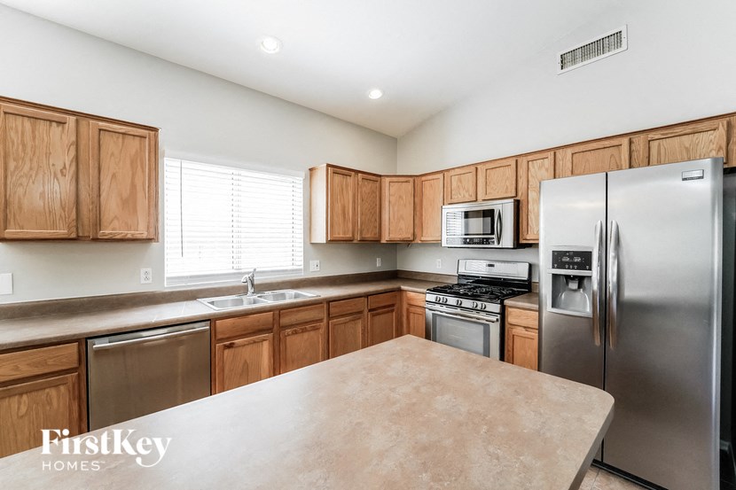 A kitchen with wooden cabinets and stainless steel appliances.