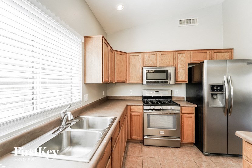 A kitchen with wooden cabinets and stainless steel appliances.