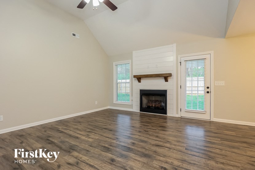 A room with a fireplace and a sliding door.