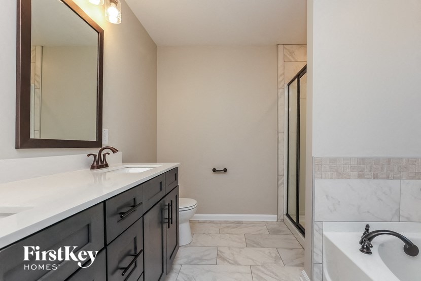 A bathroom with a marble floor and a white sink.