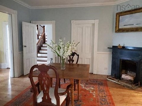a dining room with a table and chairs and a fireplace