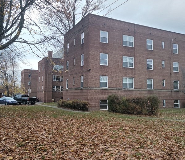 a large brick building with a truck parked in front of it