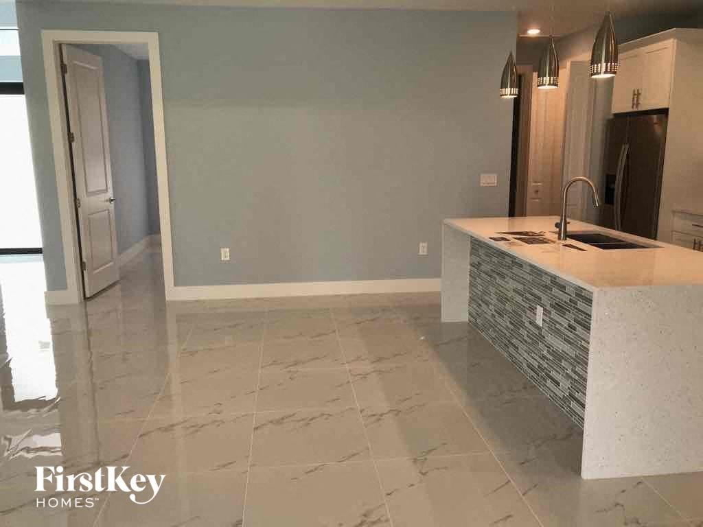 A kitchen with a white counter top and a sink.