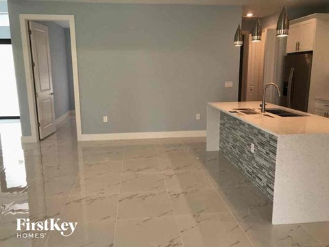 A kitchen with a white counter top and a sink.