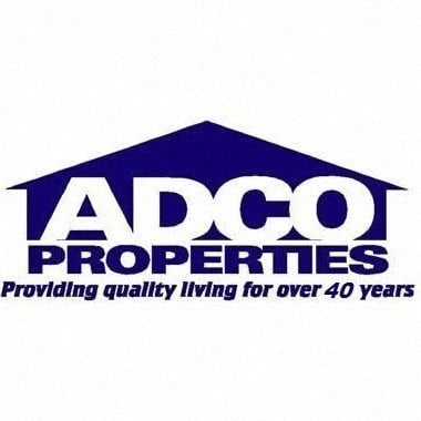 a logo for ado properties providing quality living for over 40 years