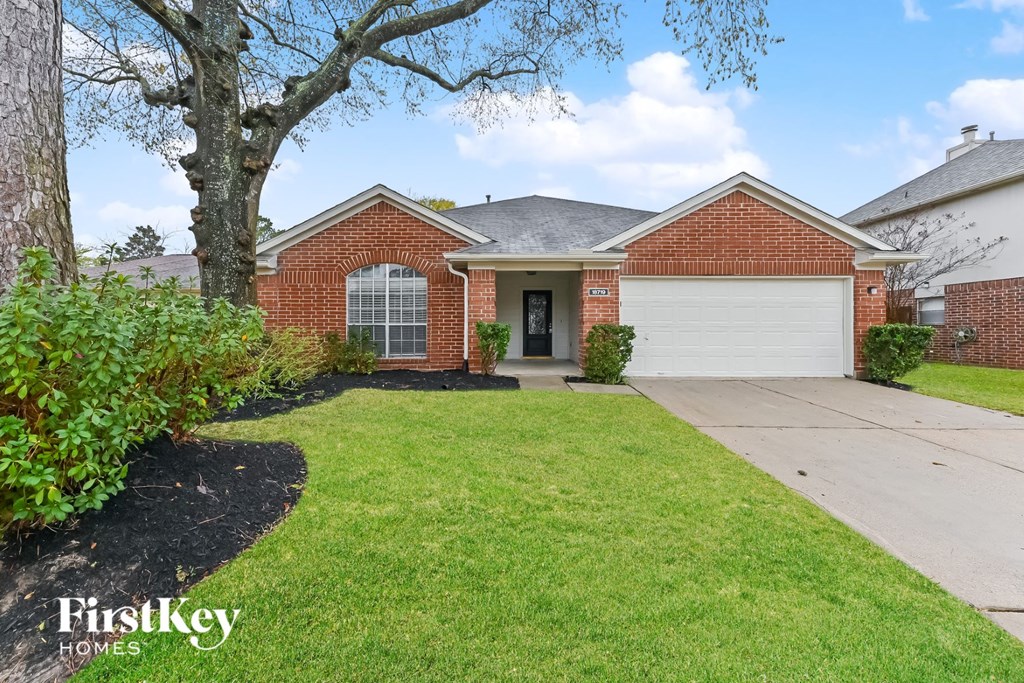 a home with a lawn and a garage