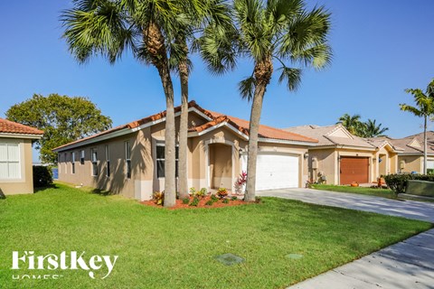 a house with palm trees in front of it