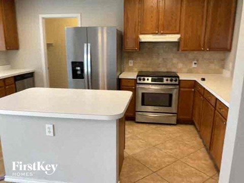 A kitchen with a stainless steel refrigerator and a stainless steel oven.