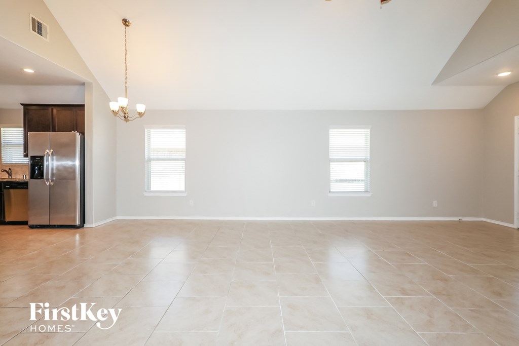 the spacious living room and kitchen with stainless steel appliances