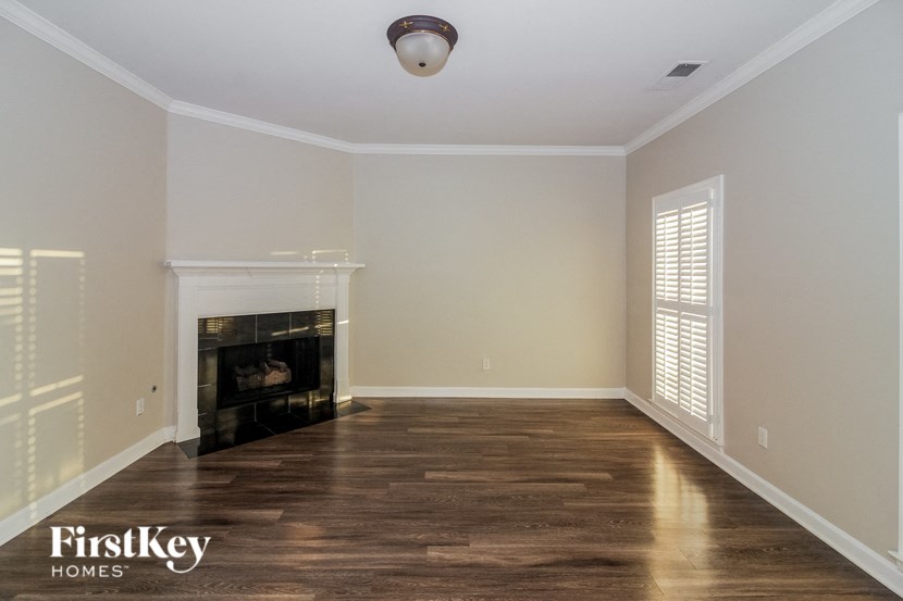 a living room with wood floors and a fireplace
