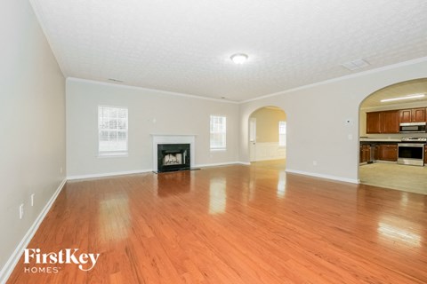 a living room with a fireplace and a wooden floor