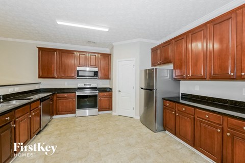a kitchen with wooden cabinets and stainless steel appliances