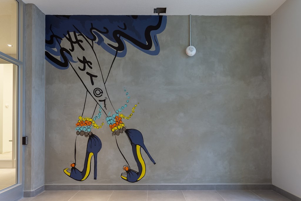 A wall mural of high heel shoes with flowers on them.