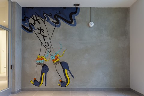 A wall mural of high heel shoes with flowers on them.