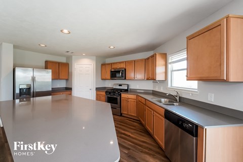 a kitchen with wooden cabinets and stainless steel countertops and a large island