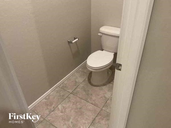 a bathroom with a white toilet in it