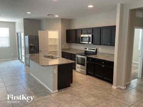 a kitchen with black cabinets and a counter top