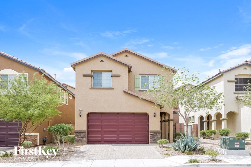A house with a red garage door is for sale.