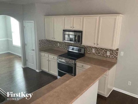 A kitchen with a counter top and cabinets.