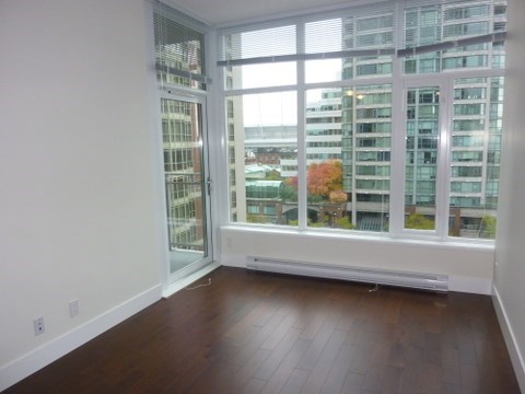 A room with a large window overlooking a cityscape.