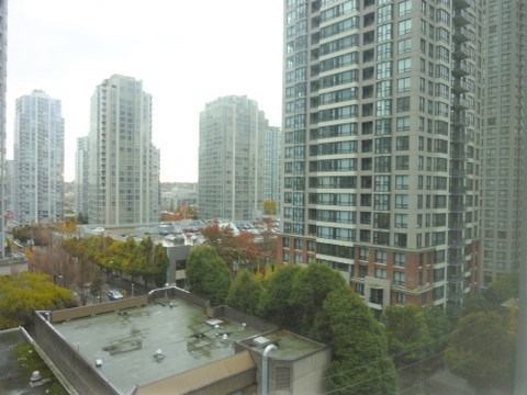 A view of a cityscape with apartment buildings and trees.