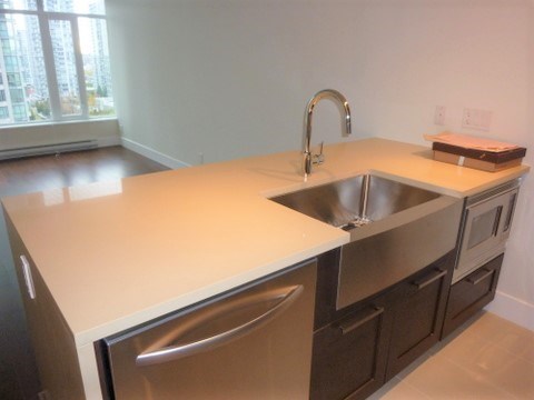A kitchen with a sink and a window.