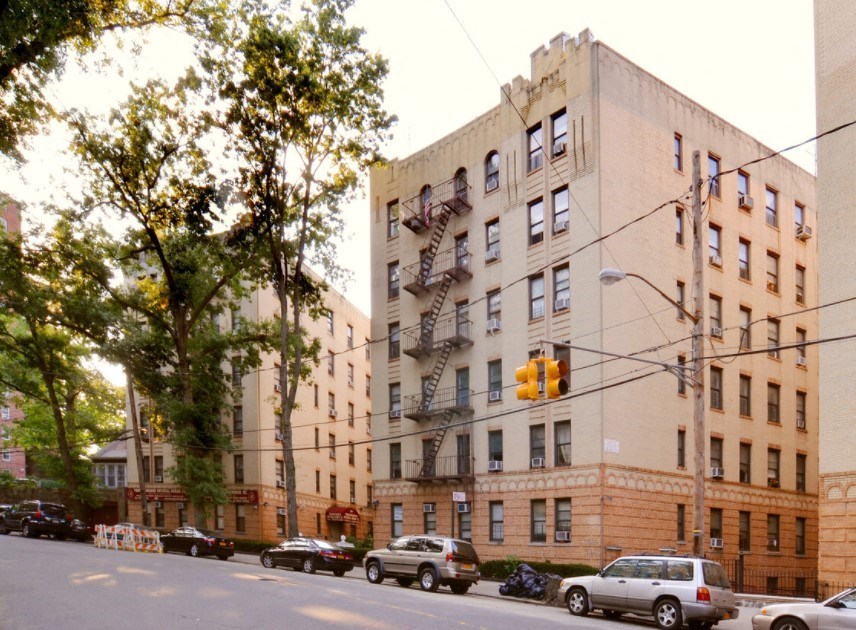 a large building with a fire escape on the side of a street