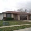 A house with a brown roof and a garage door.