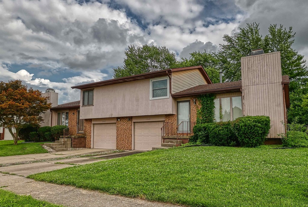 A house with a brown roof and a garage door.