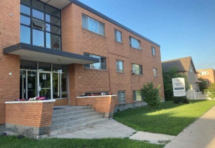 a large brick building with a sign in front of it