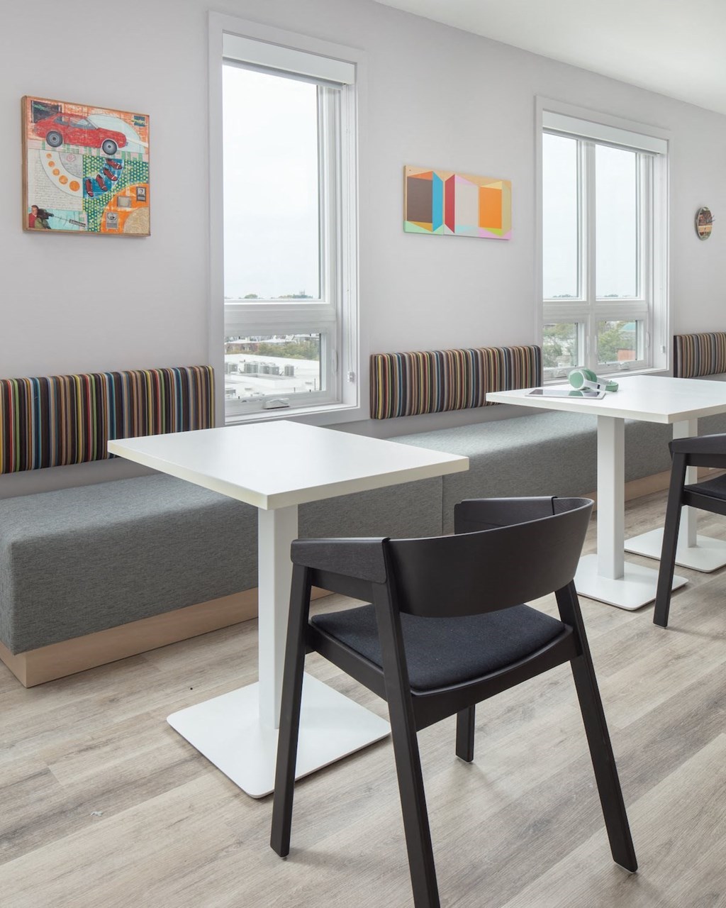a seating area with tables and chairs in a room