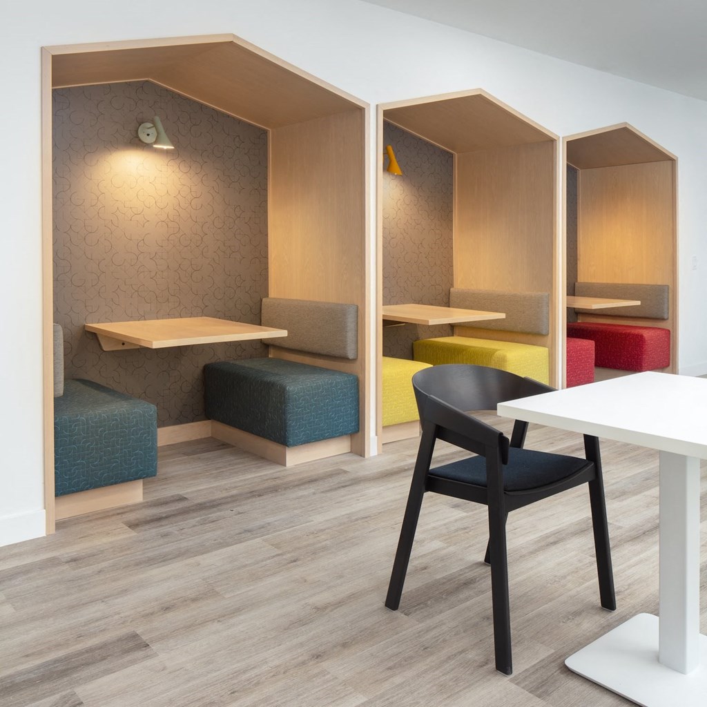 a room with a table and a chair and some dividers