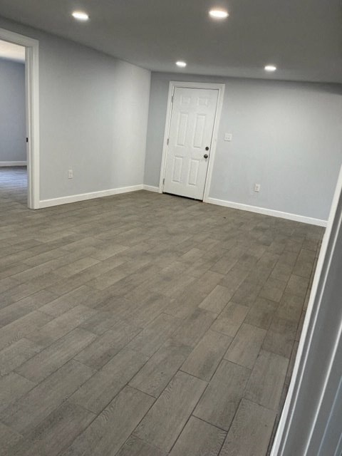 a empty living room with a door and tile floor
