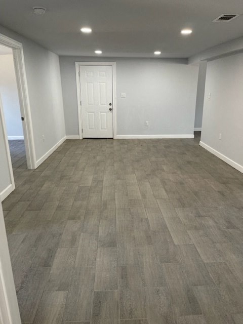 a living room with a wooden floor and a white door