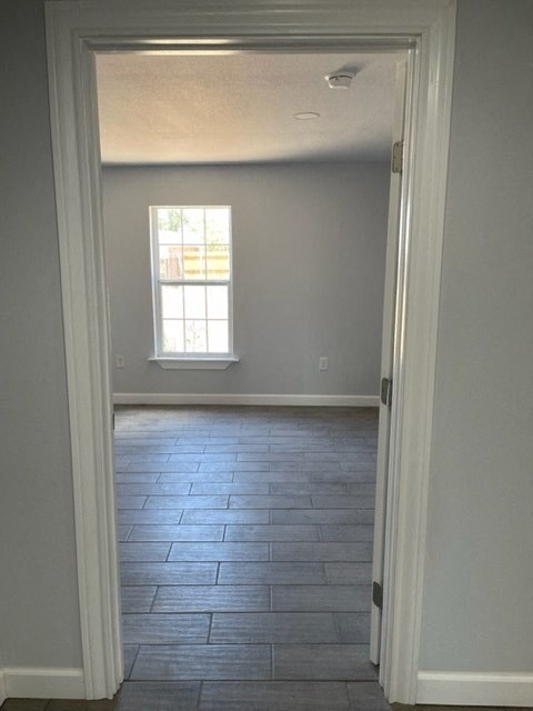 a empty room with a window and a tiled floor