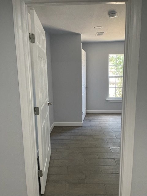 a hallway with a white door and a window