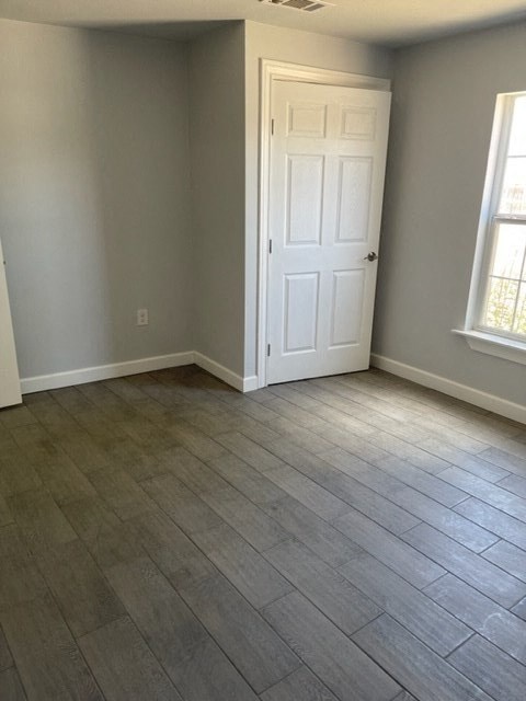 a empty room with a door and a wooden floor