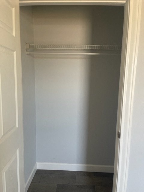 an empty closet with a white wall and a white door