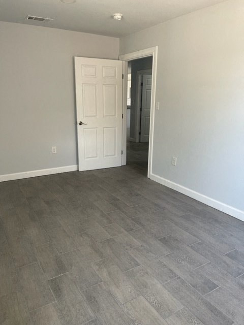 a empty room with a door and a hallway