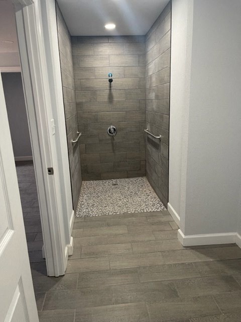 a bathroom with a tiled shower in it