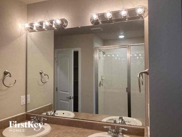 a bathroom with two sinks and a large mirror