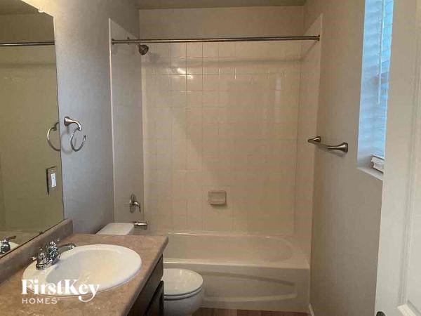 a bathroom with a shower toilet and a sink